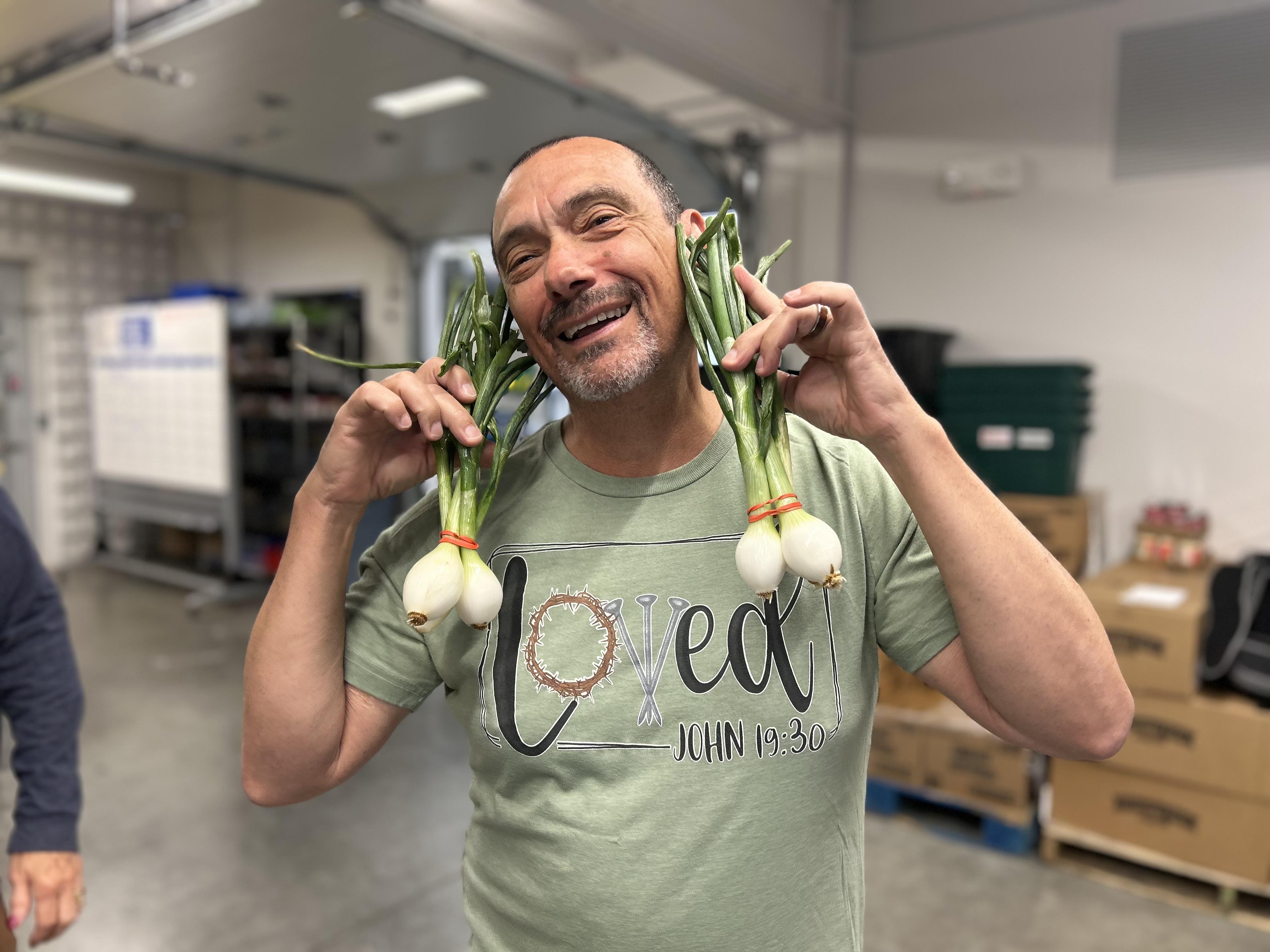 Man holding onions