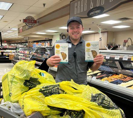 Man holding boxes of pasta 