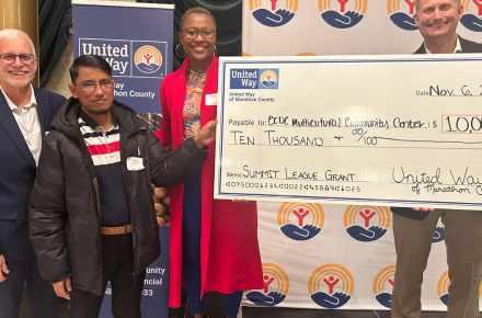 People holding a big check