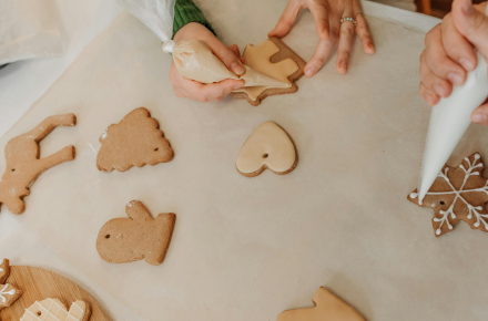 Cookies on a counter person frosting cookies