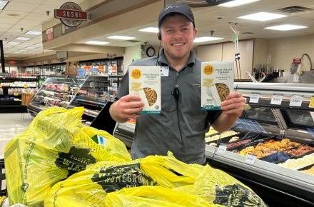 Man holding boxes of pasta 