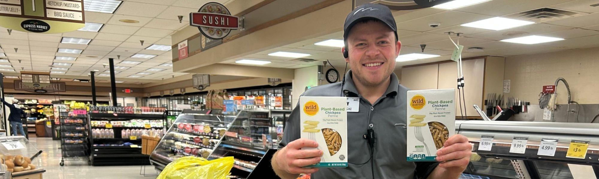 Man holding two boxes of pasta