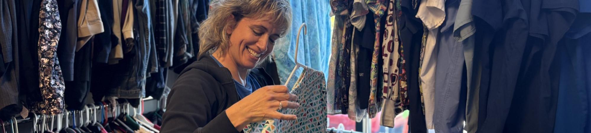 Woman hanging clothes on a rack 