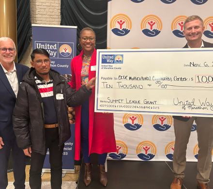 People holding a big check