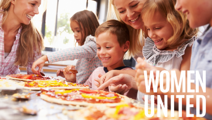 Women and kids making pizza